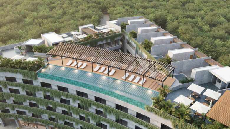 Rooftop de Macondo Tulum con alberca infinity, camastros bajo pérgola de madera, área lounge y vistas panorámicas a la selva, representando los departamentos en venta en Tulum.