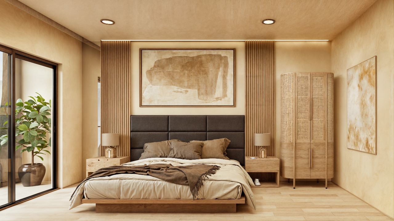 Dormitorio de una unidad en Macondo Corazón con cama de diseño contemporáneo, cabecera tapizada en tono oscuro, mobiliario de madera clara, lámparas de mesa, arte minimalista en las paredes y ventanal con salida a terraza y planta decorativa. Espacio que refleja la serenidad y el diseño de los departamentos en venta en Playa del Carmen.